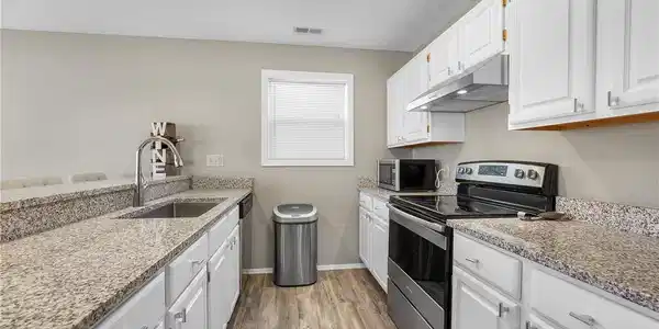 Image 4: Updated kitchen with granite and stainless applian