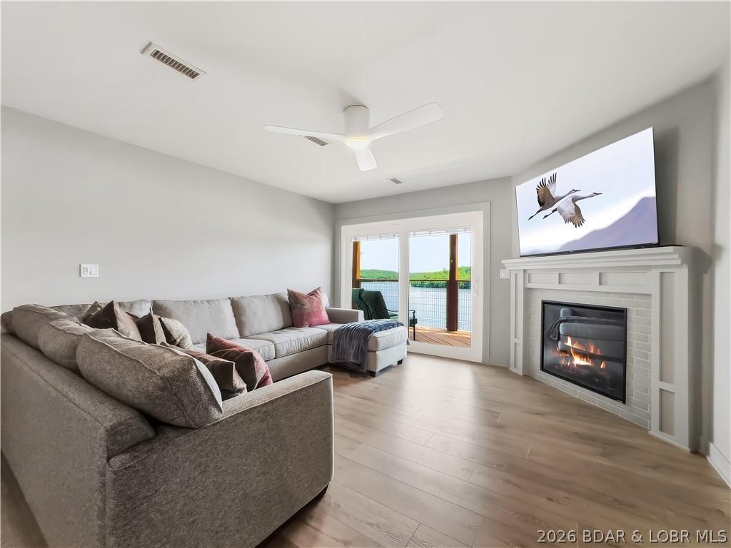 Image 2: The spacious living room features a beautiful fire