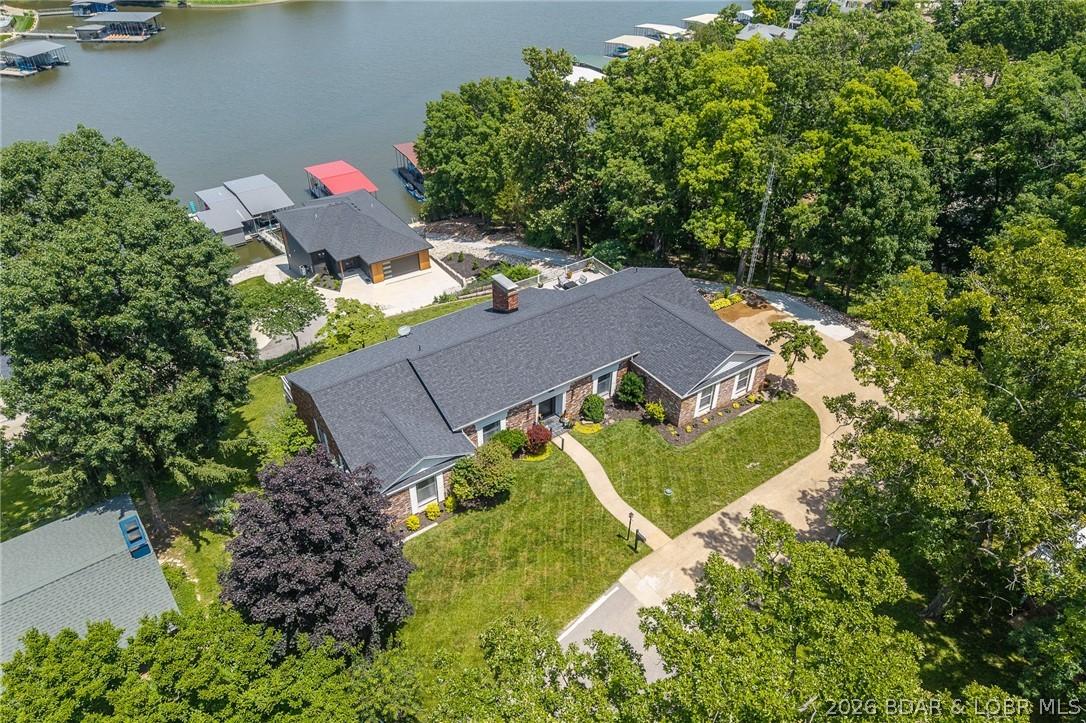 Image 4: Aerial view of home and lake