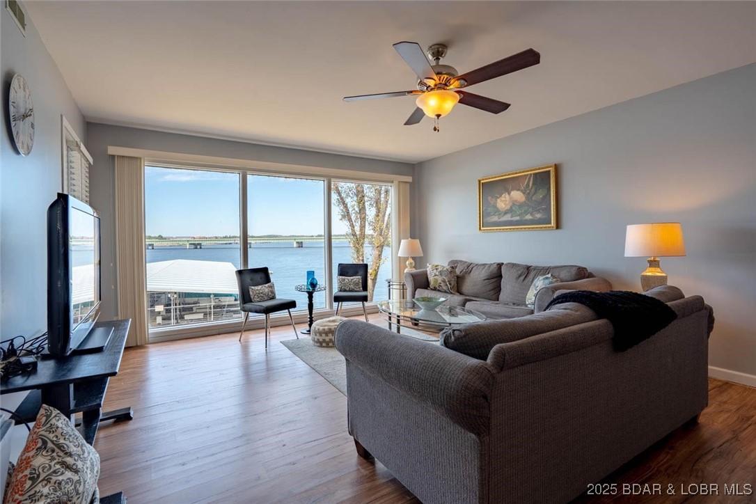 Image 2: Open floor plan with a ton of lakeside windows