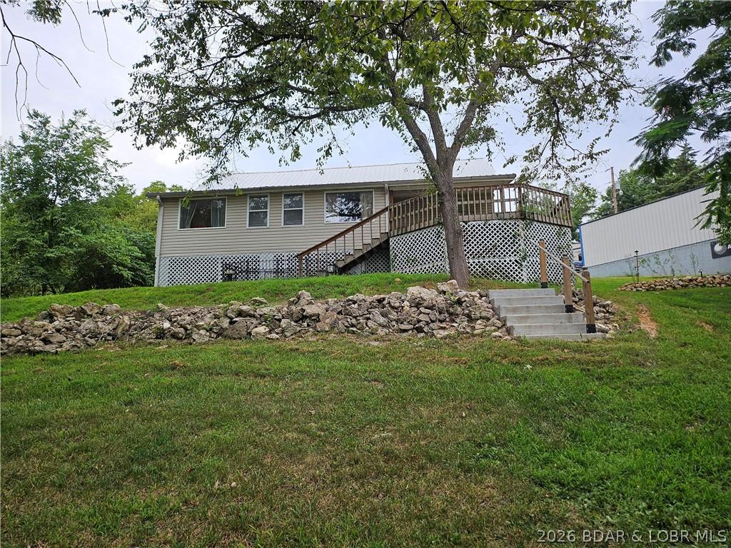 Image 1: Lakeside view of house