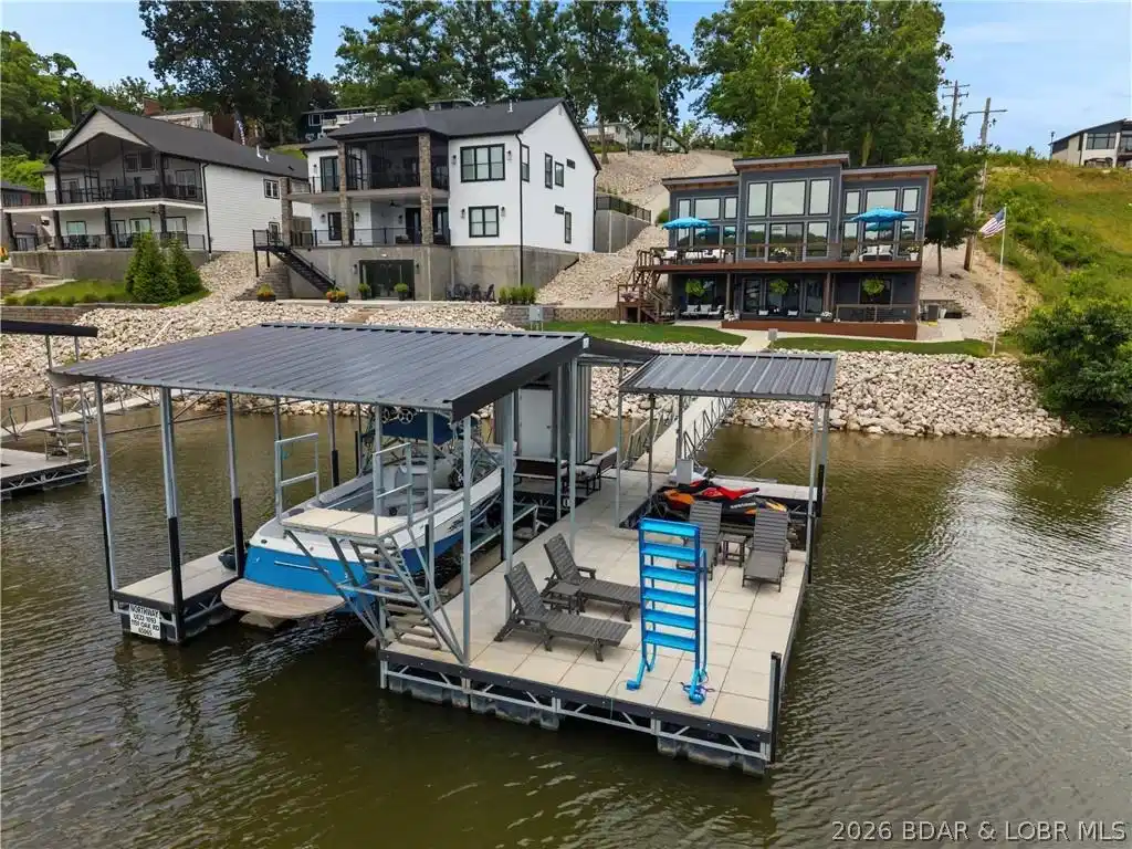 Image 1: Private waterfront setting featuring a gentle lot,