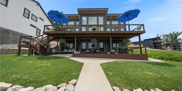 Image 2: Beautiful lakeside elevation showcasing expansive