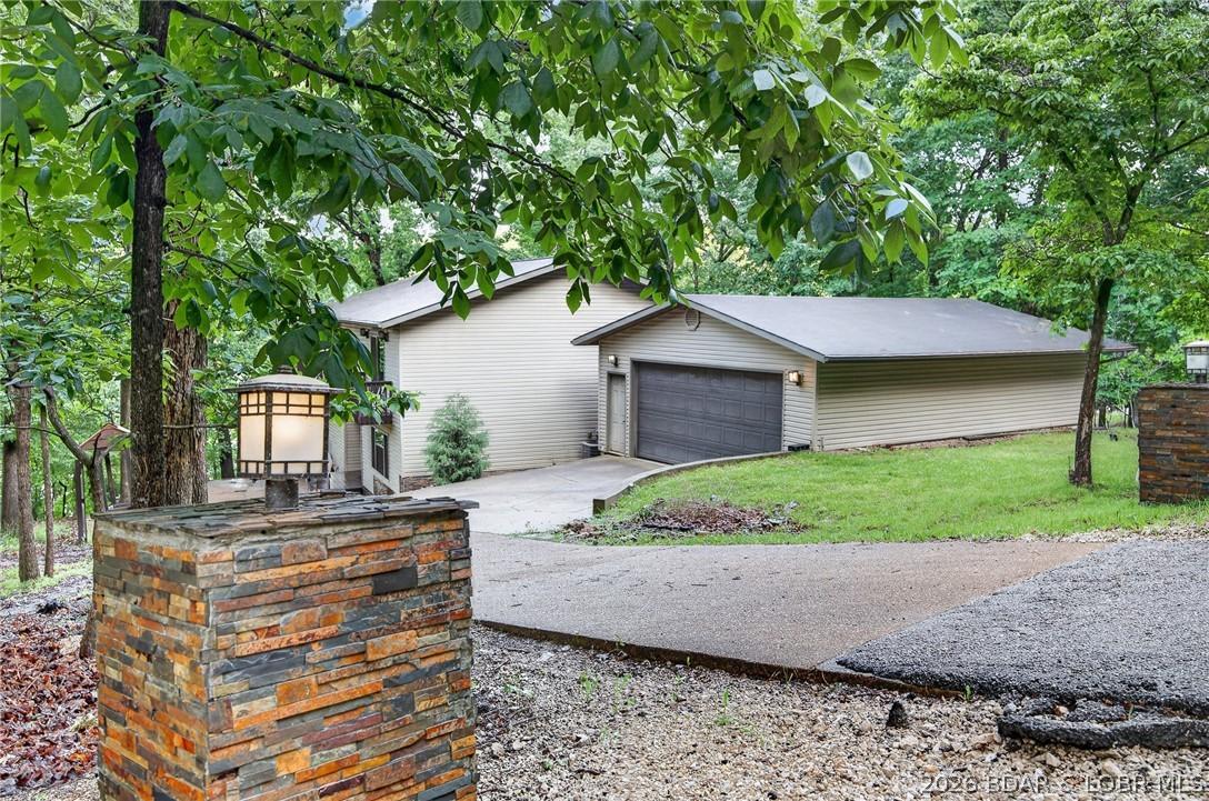 Image 4: Road Side View of Home and Garage
