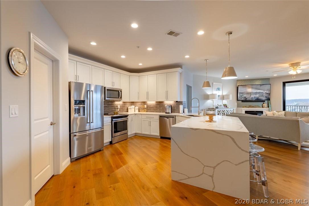 Image 3: Gourmet kitchen - huge island w/waterfall quartz c