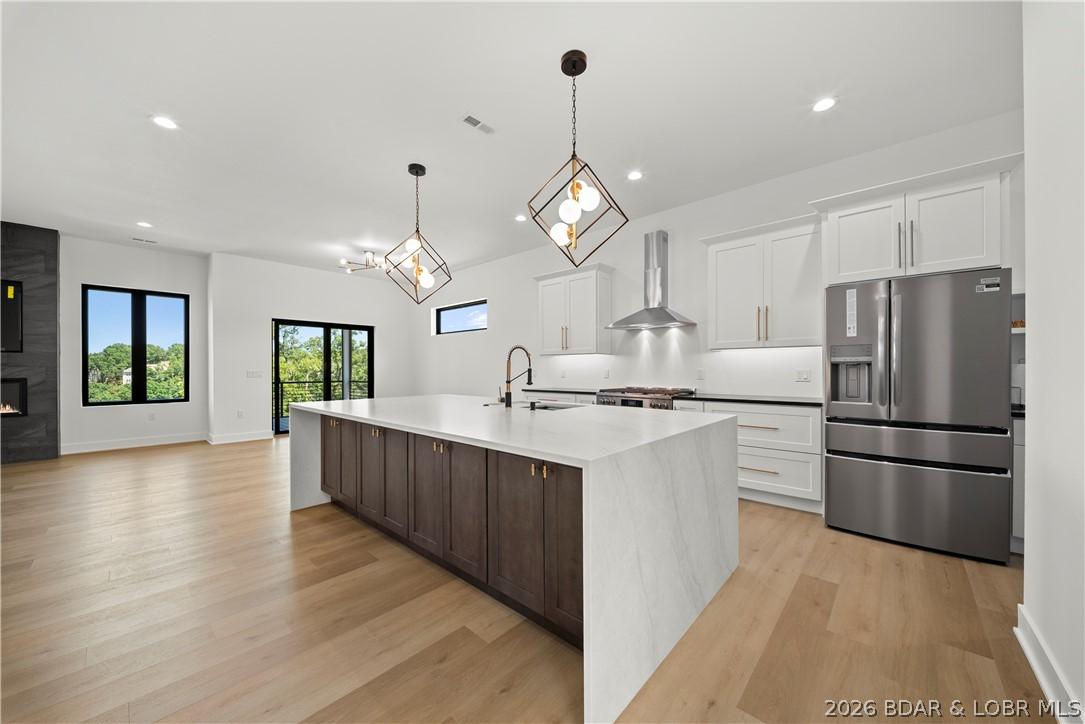Image 4: Bright open-concept kitchen with oversized island,