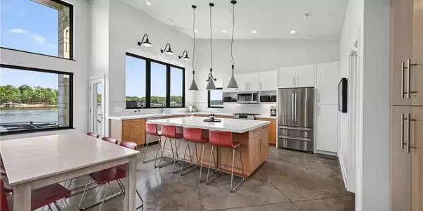 Image 4: Sleek modern kitchen with endless natural light an