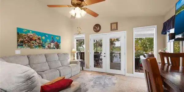 Image 3: Living room has vaulted ceilings and a wall of win
