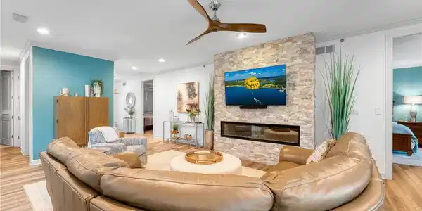 Image 2: The beautiful stacked stone fireplace is the cente