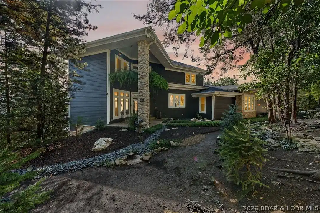 Image 1: Expansive landscape around the front of the home w