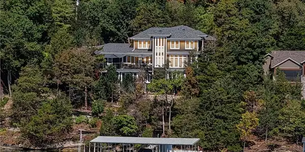 Image 2: Lake view of the rear of the home.