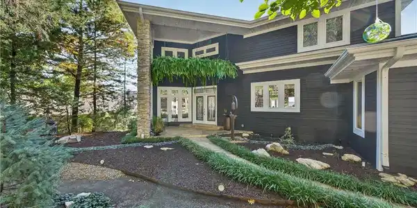 Image 3: Front view of the home with the expansive landscap