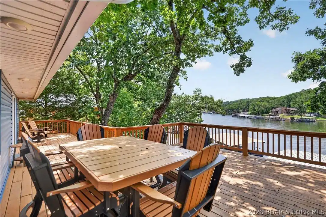 Image 1: Expansive Lakeside Deck Overlooking the Water