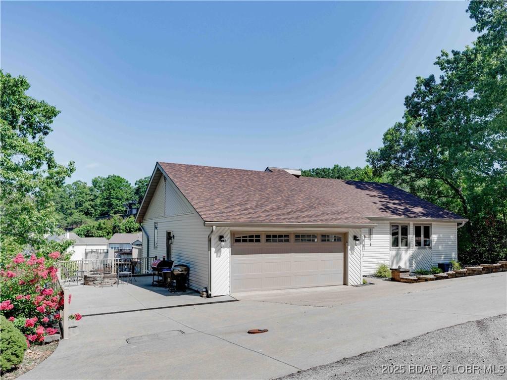 Image 3: Beautiful landscaping and concrete driveway