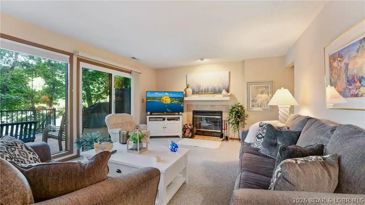 Image 1: Bright and open living room featuring a cozy firep