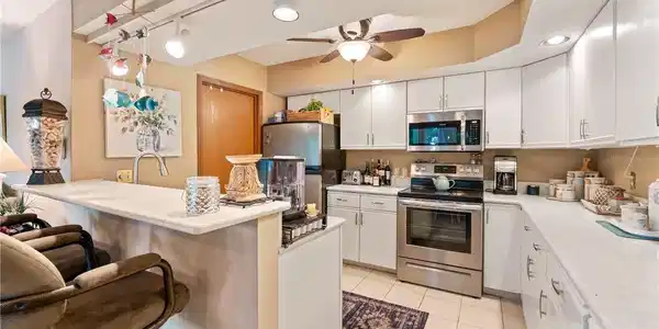 Image 4: This kitchen features a modern aesthetic with brig