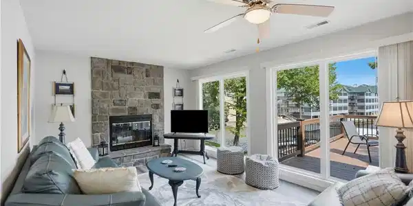 Image 3: Spacious living room with large windows and open l