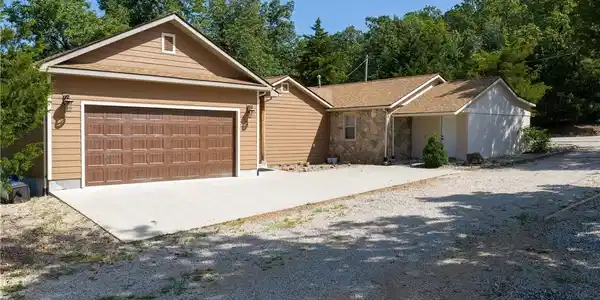 Image 3: This detached garage features two main bays for st