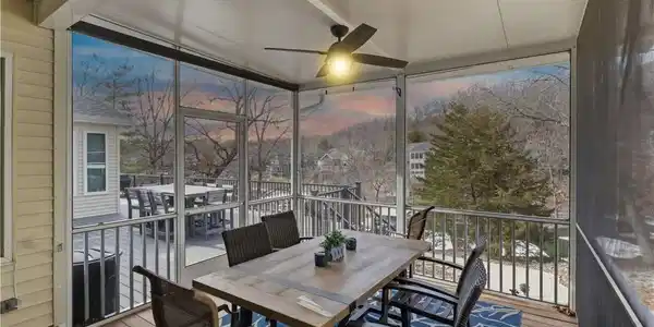 Image 3: Screened in dining with a TV