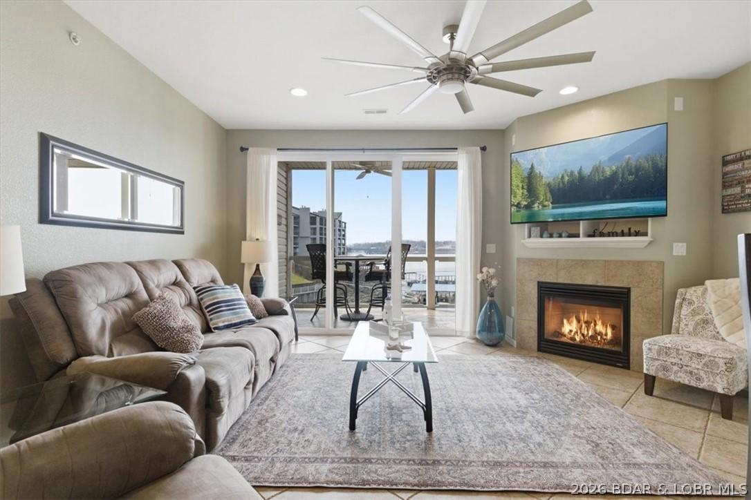 Image 1: Spacious living room area with a fireplace that us
