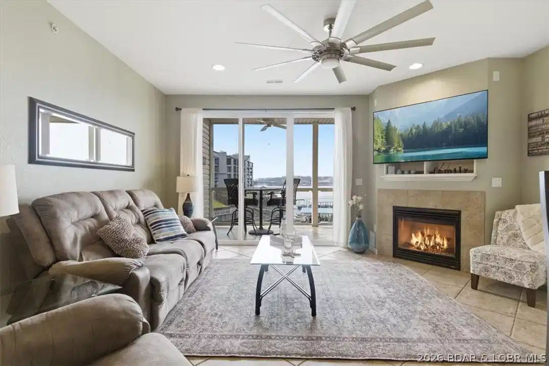 Image 1: Spacious living room area with a fireplace that us