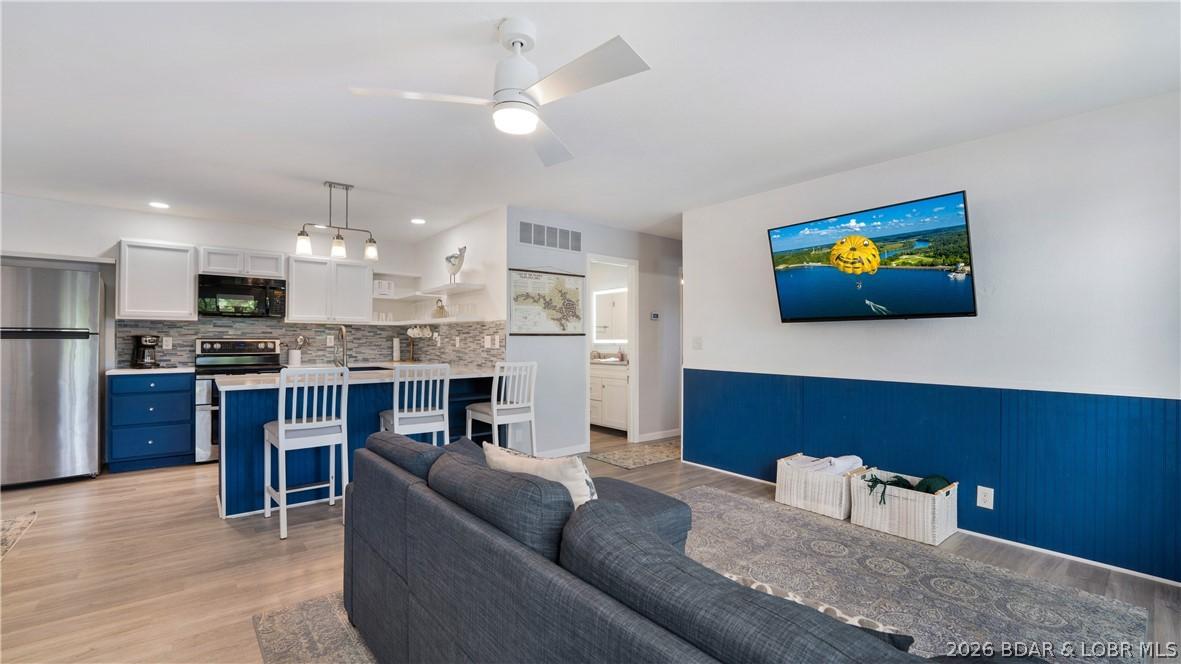 Image 4: Open concept kitchen and living room area.