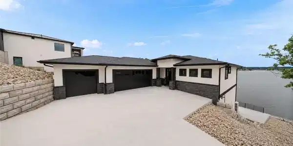 Image 2: Grand front approach with oversized driveway, thre