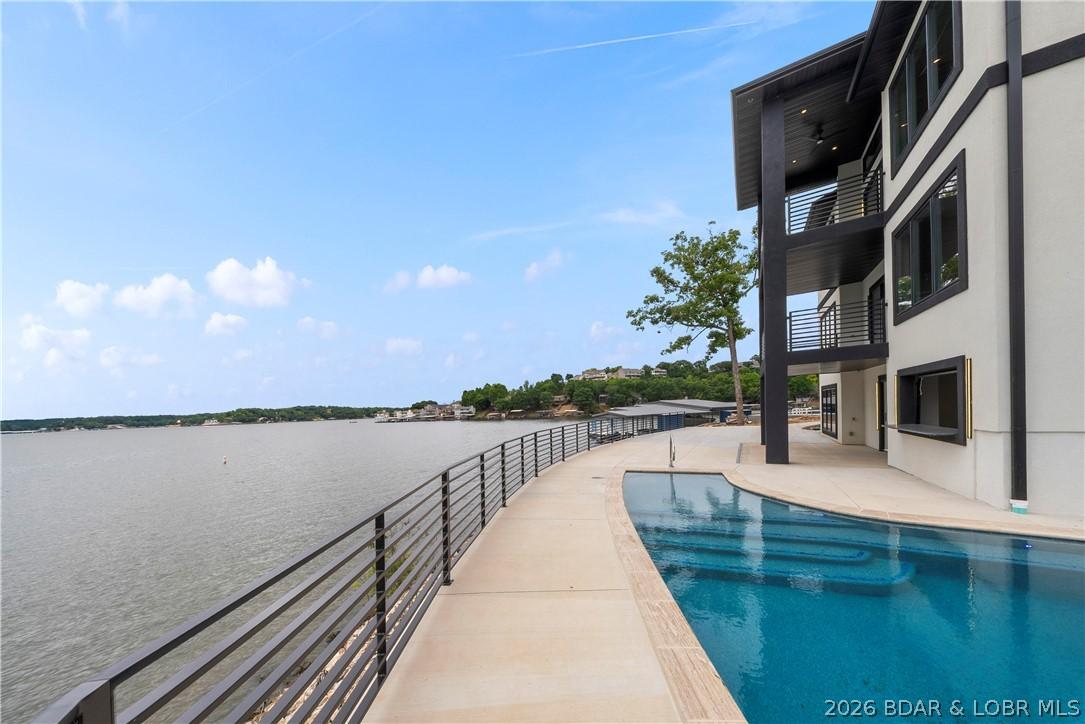 Image 4: Resort-inspired pool overlooking panoramic lake vi