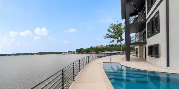 Image 4: Resort-inspired pool overlooking panoramic lake vi