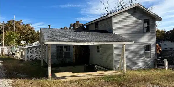 Image 3: Front of Home with Carport.