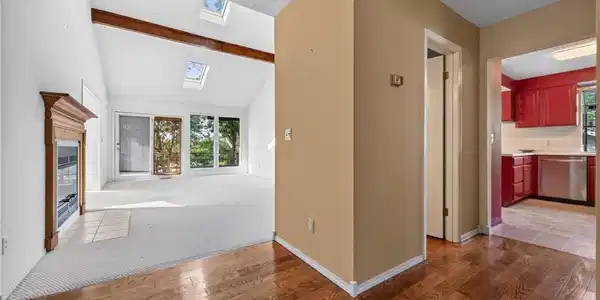 Image 2: Dramatic entry - hardwood floors - powder room to