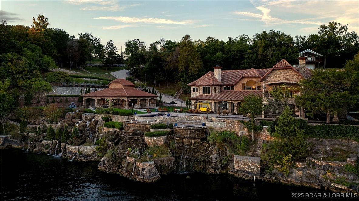 Image 4: Pool, spa, patios, covered lounge with fireplace,