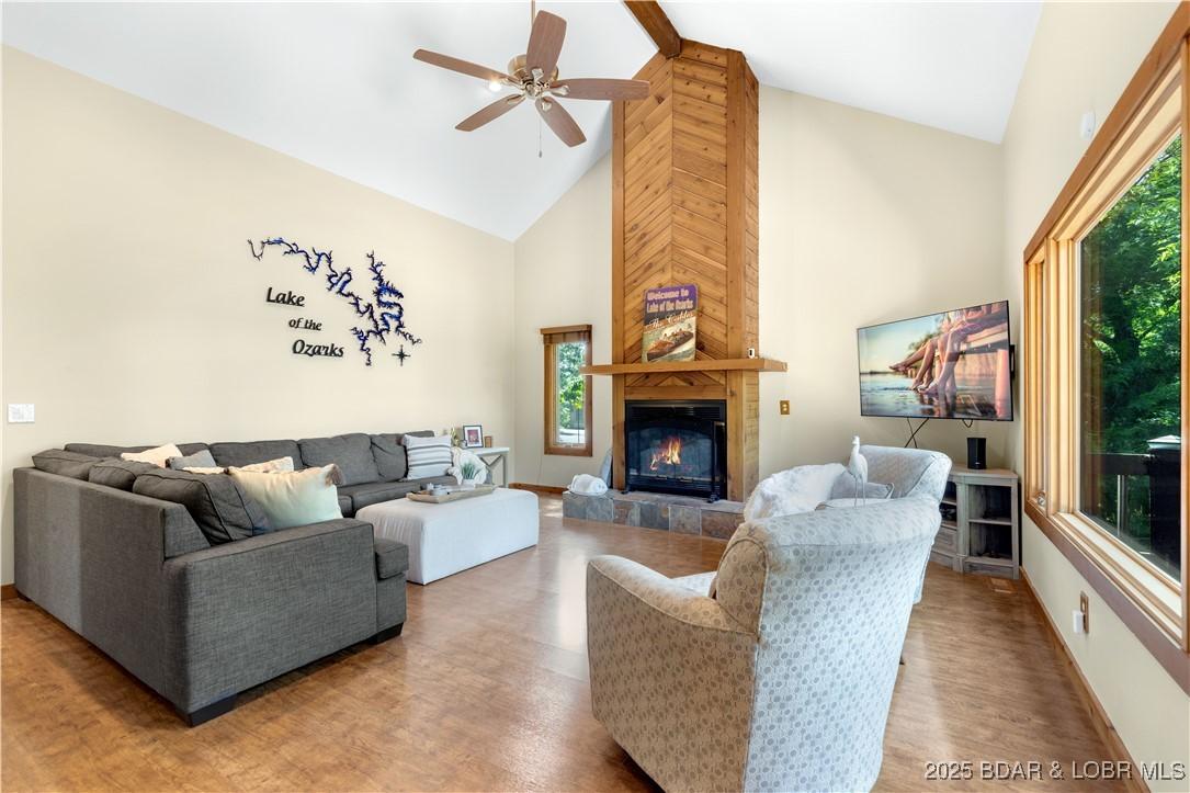 Image 4: Spacious living area focuses on the cozy fireplace