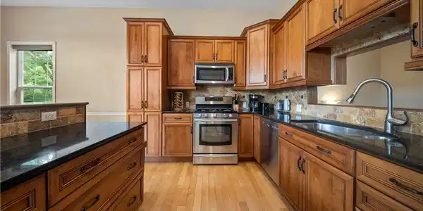 Image 2: Large open concept kitchen with custom cabinets