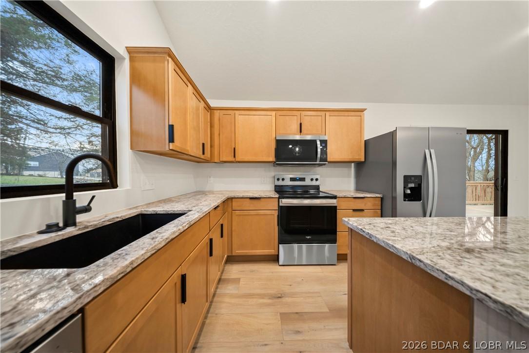 Image 2: Granite countertops and plenty of cabinet space in
