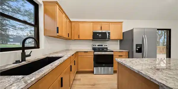Image 2: Granite countertops and plenty of cabinet space in