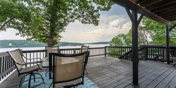 Image 3: Large deck off the living room is partially covere