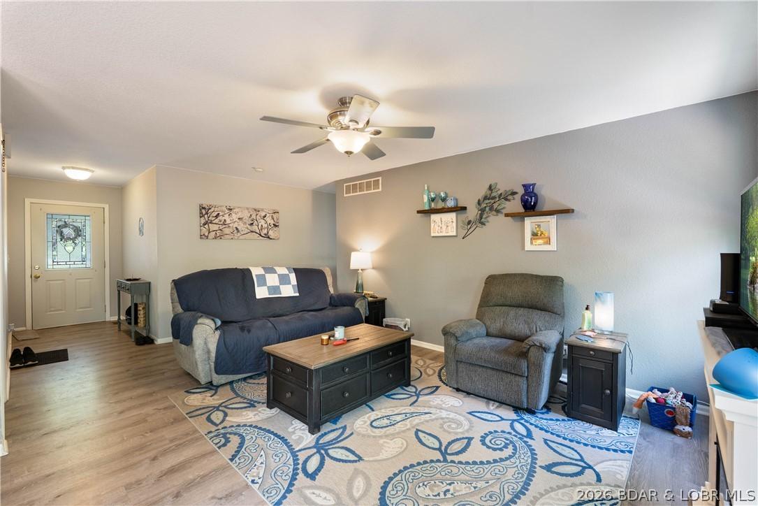 Image 2: Bright, open living room with newer LVP flooring a