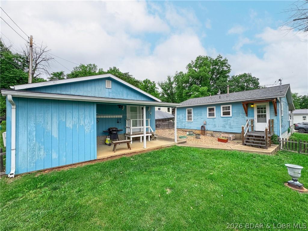 Image 3: Back yard featuring storage/detached garage & back