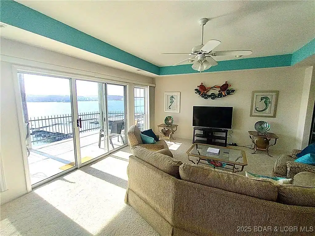 Image 1: Living room with lake view