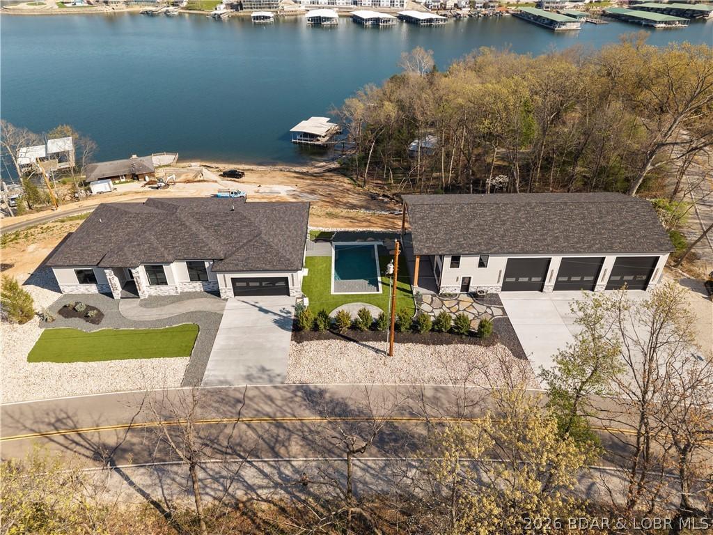 Image 3: Overhead view of shot of primary home, pool, and s
