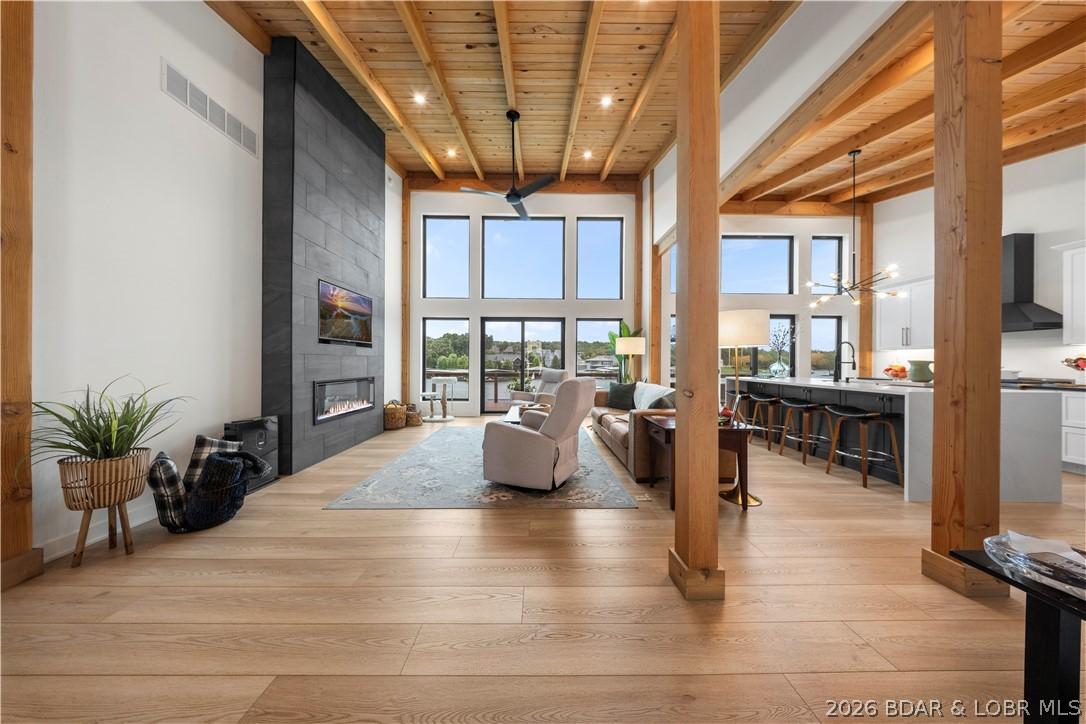 Image 1: Stunning open-concept living area with soaring cei