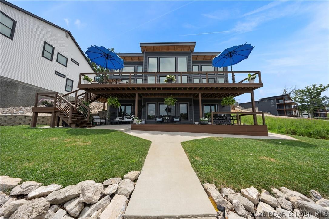 Image 2: Beautiful lakeside elevation showcasing expansive