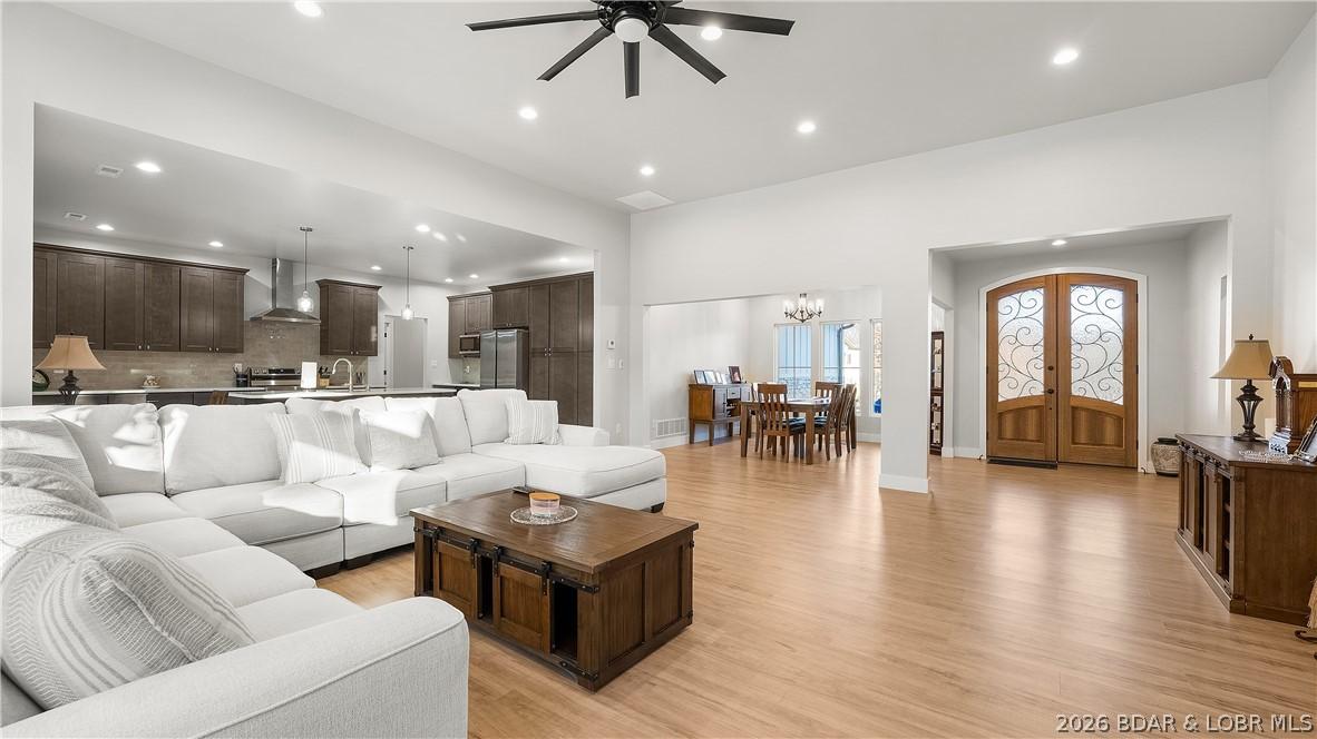 Image 3: Large living room with soaring ceilings.