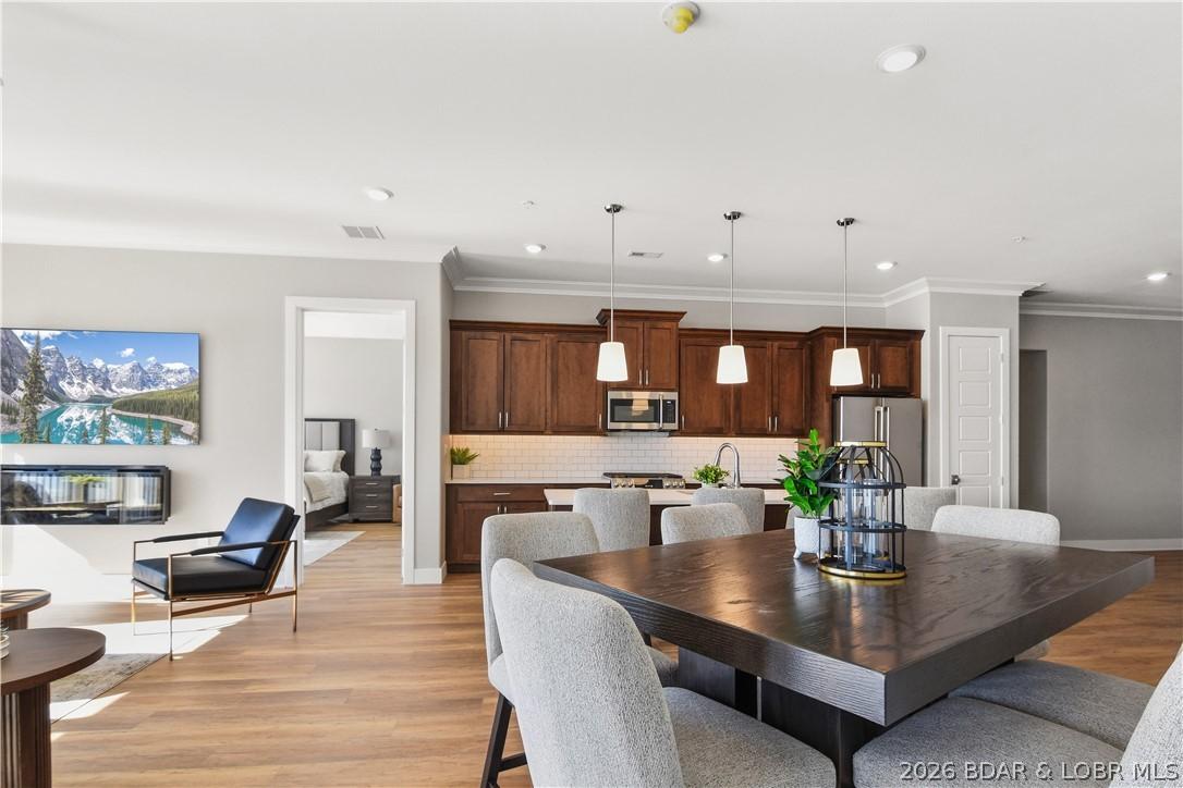 Image 2: The tall ceilings and light color palette help add