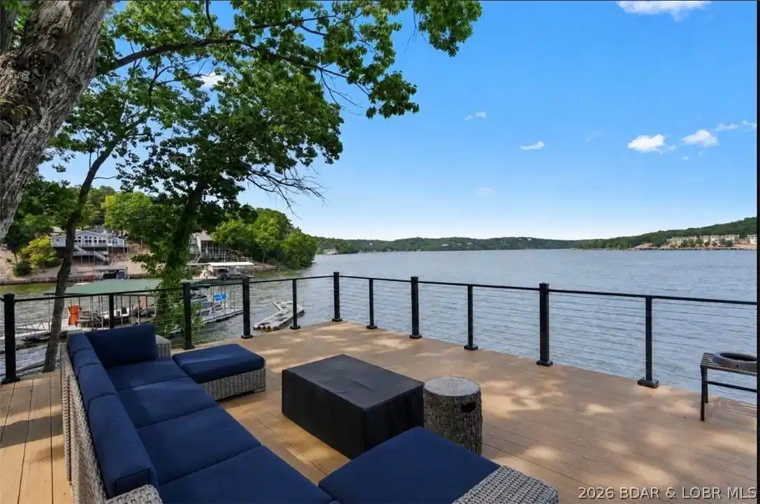 Image 1: Expansive waterfront deck with panoramic lake view