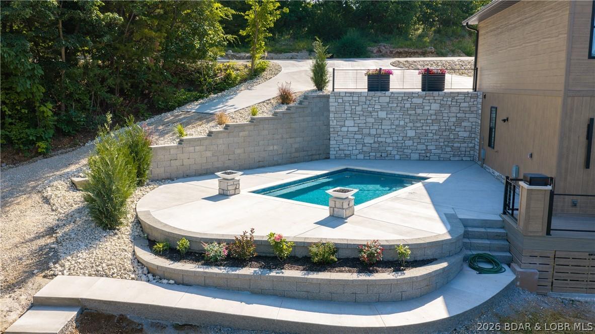 Image 3: Lakeside pool with gas fire bowls