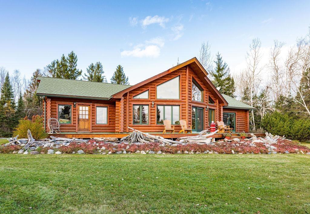 Image 0: Back of house with log siding, a yard, and a shingled roof, Back Of Structure