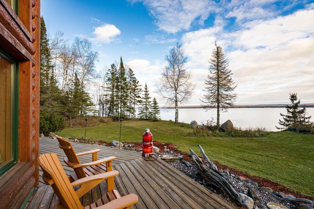 Image 2: Deck featuring a water view and a yard, Deck