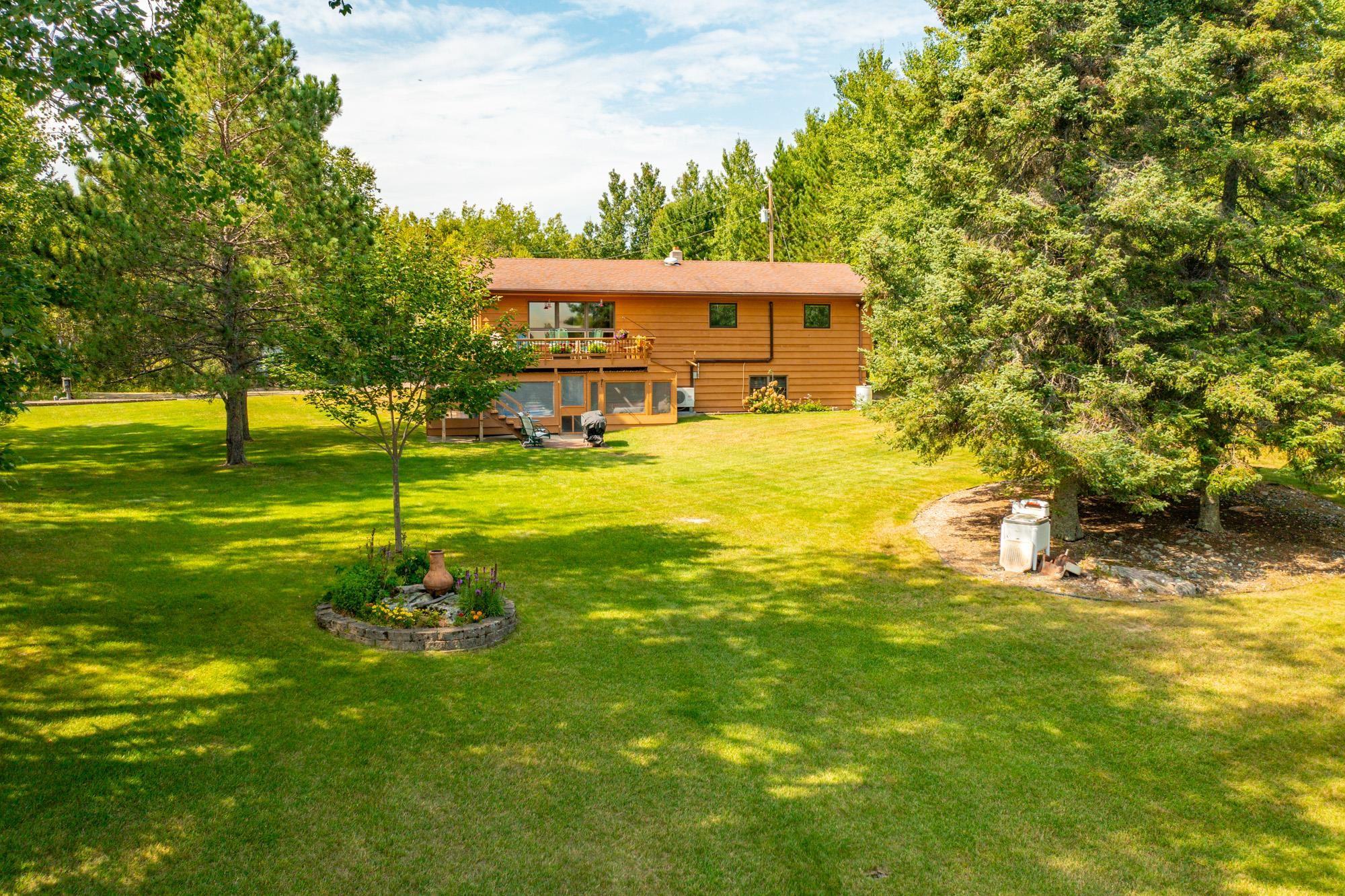 Image 0: View of green lawn featuring a deck, Yard